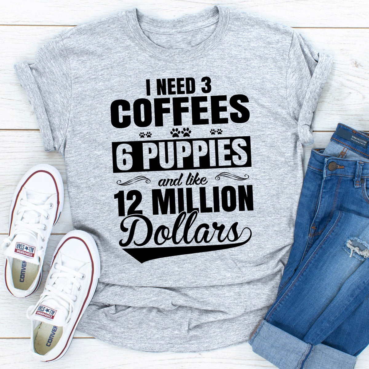 I Need 3 Coffees 6 Puppies And Like 12 Million Dollars T-Shirt displayed on a mannequin, showcasing its soft cotton fabric and unique design.