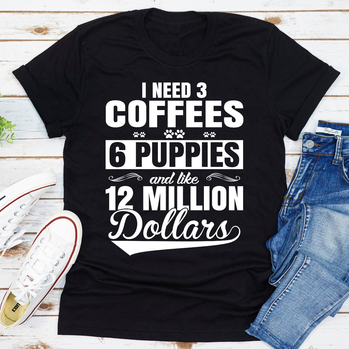 I Need 3 Coffees 6 Puppies And Like 12 Million Dollars T-Shirt displayed on a mannequin, showcasing its soft cotton fabric and unique design.