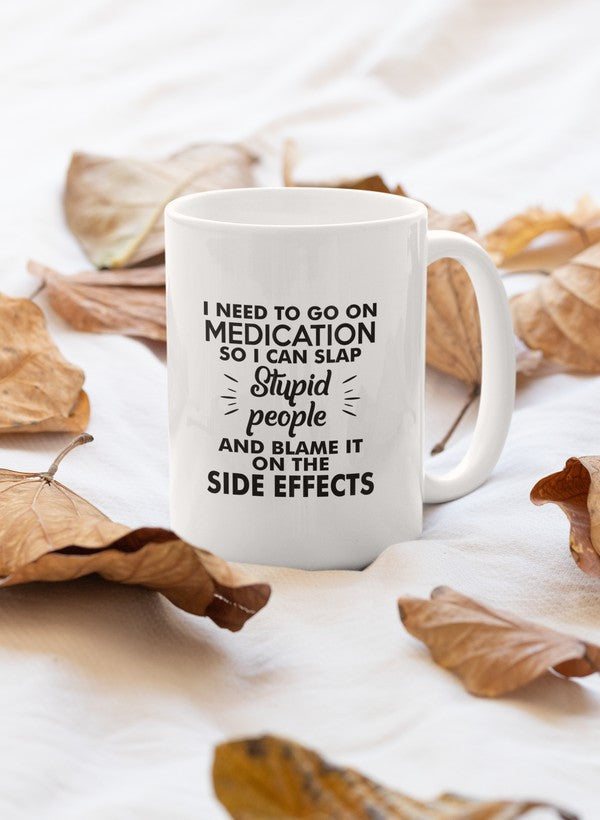 A glossy white ceramic mug with the phrase 'I Need To Go On Medication' printed in bold letters, featuring a sturdy handle.