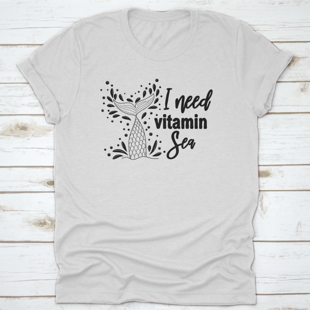 A stylish 'I Need Vitamin Sea' T-Shirt featuring artistic design, made from 100% cotton, perfect for beach lovers.