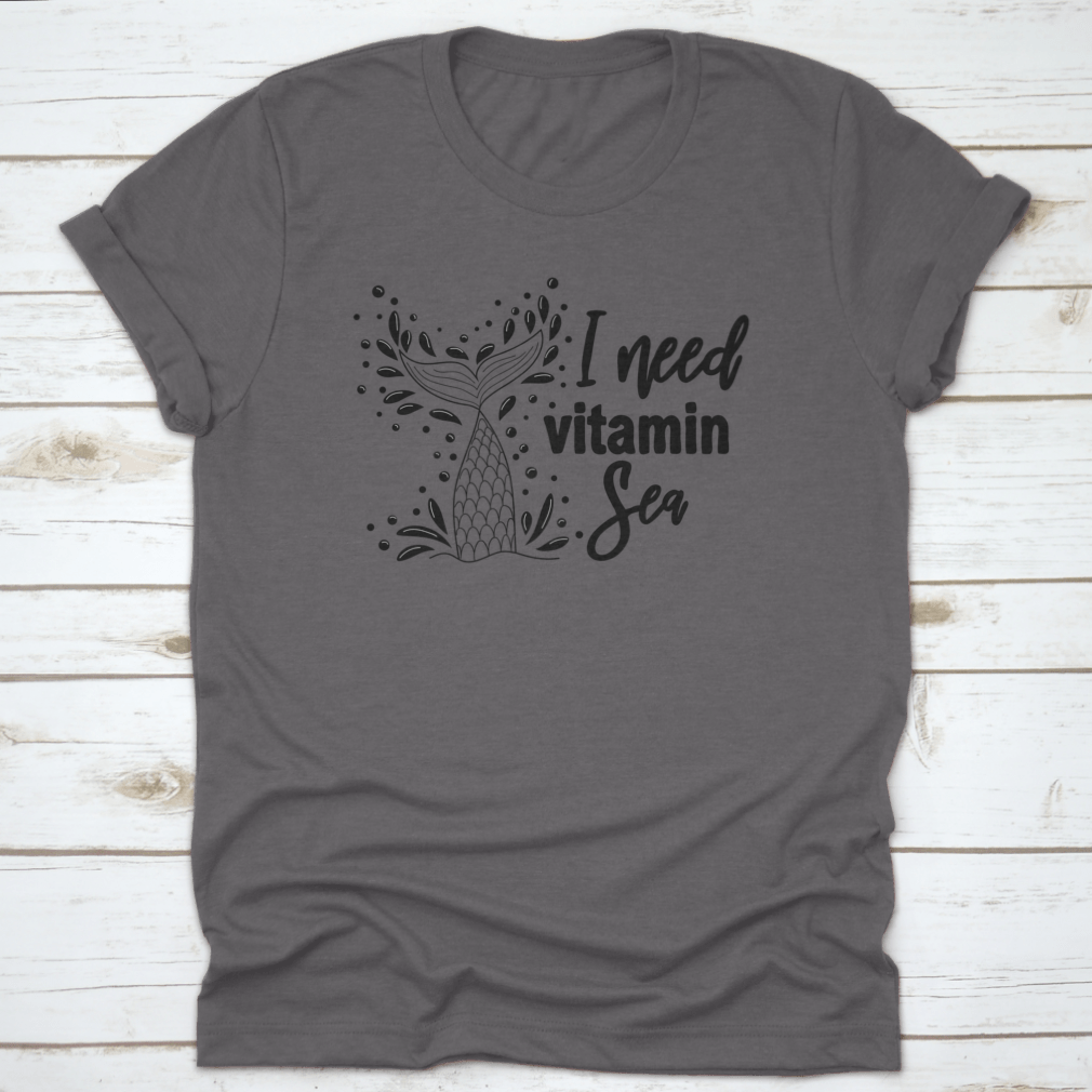 A stylish 'I Need Vitamin Sea' T-Shirt featuring artistic design, made from 100% cotton, perfect for beach lovers.