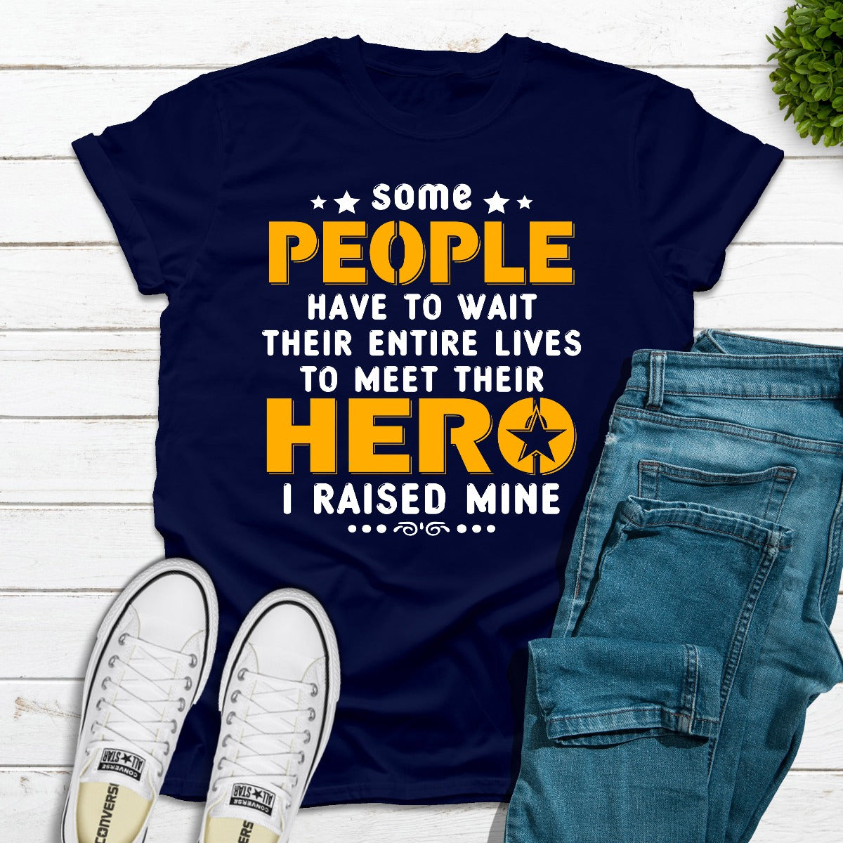 I Raised My Hero T-Shirt displayed on a hanger, showcasing its soft cotton fabric and vibrant print.