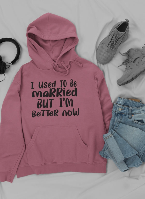 A stylish hoodie featuring the phrase 'I Used To Be Married But I'm' designed by top artists, showcasing a cozy cotton/poly fleece blend.