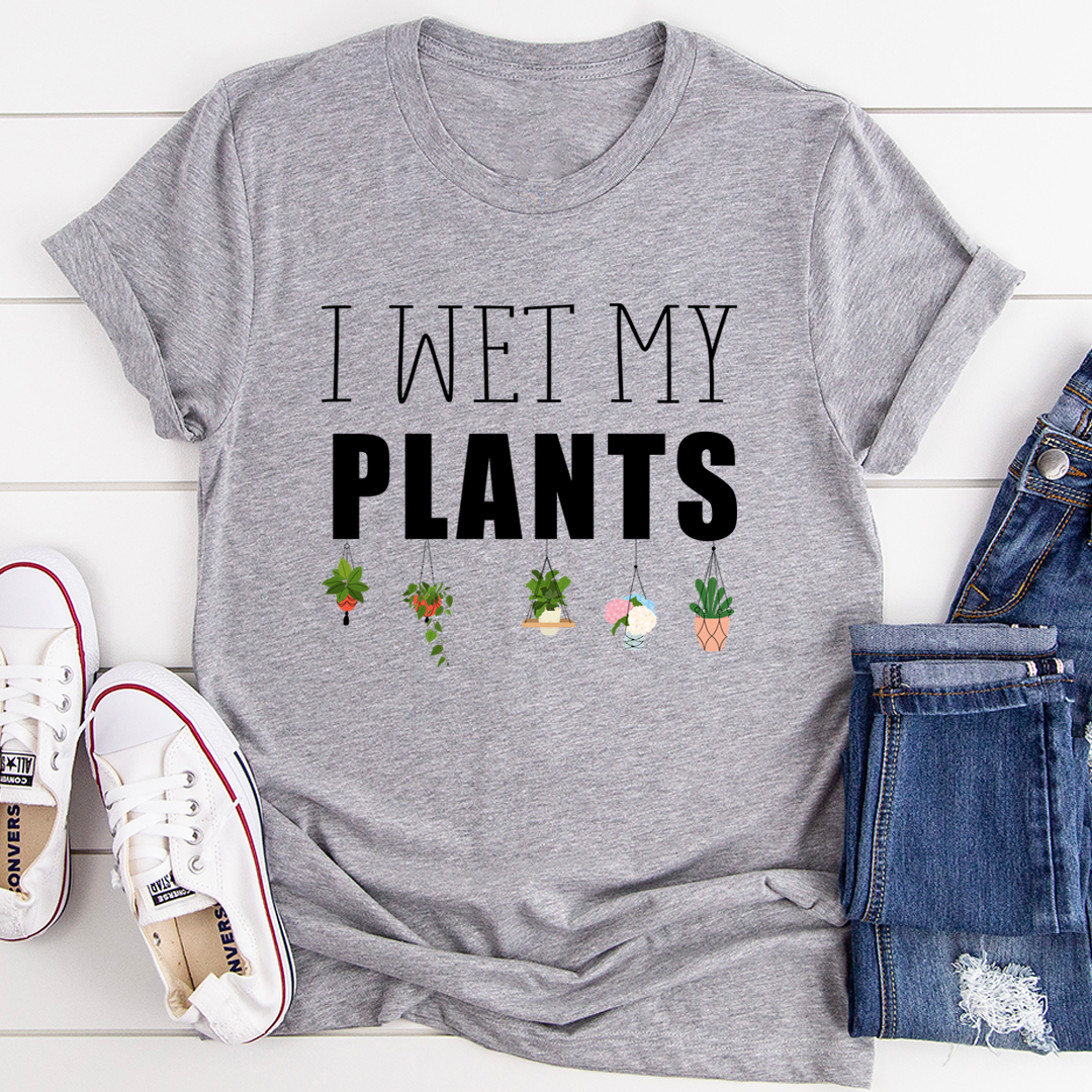 I Wet My Plants T-Shirt displayed on a hanger, showcasing its soft cotton fabric and humorous design.