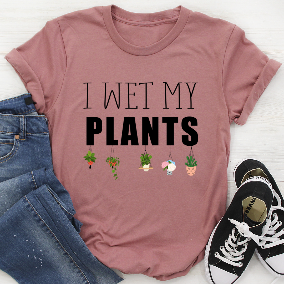 I Wet My Plants T-Shirt displayed on a hanger, showcasing its soft cotton fabric and humorous design.