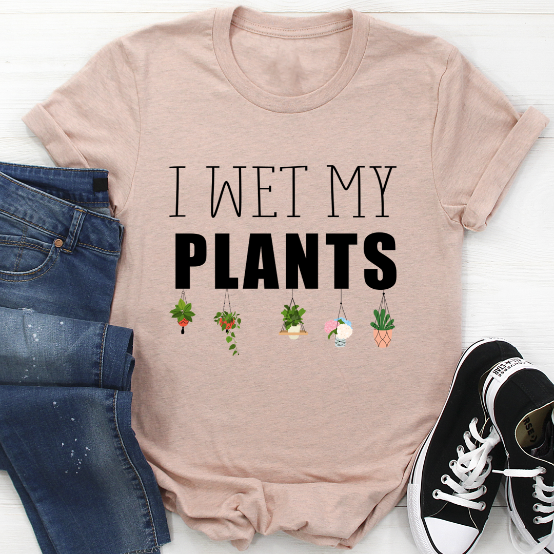 I Wet My Plants T-Shirt displayed on a hanger, showcasing its soft cotton fabric and humorous design.