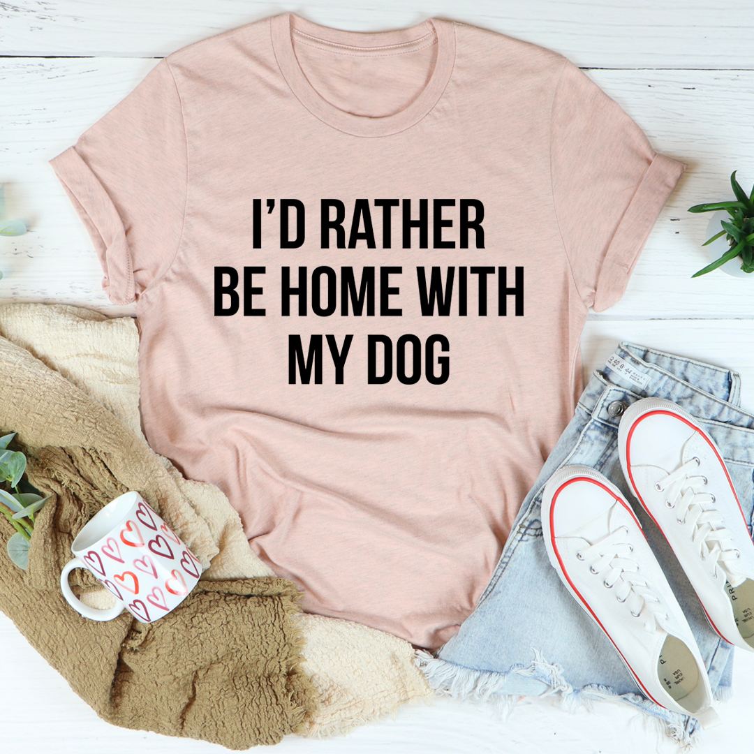 A comfortable and stylish t-shirt featuring the phrase 'I'd Rather Be Home With My Dog', made from soft ring-spun cotton.