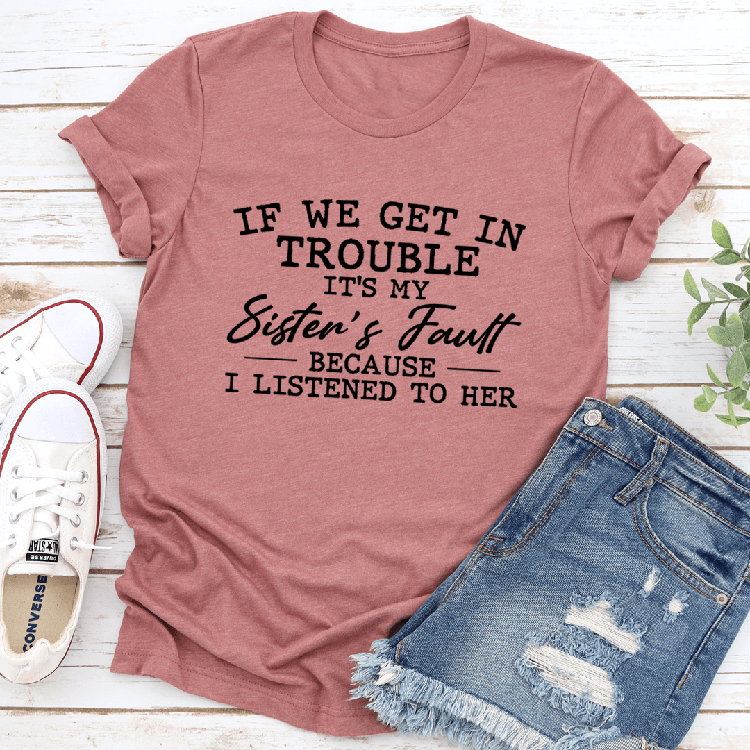 If We Get In Trouble It's My Sister's Fault T-Shirt displayed on a hanger, showcasing its soft cotton fabric and humorous design.