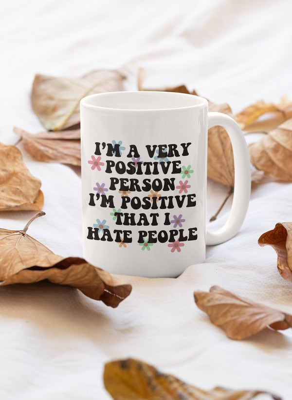 A glossy 11oz ceramic mug with the phrase 'I'm A Very Positive Person' printed on it, featuring a sturdy handle and vibrant colors.