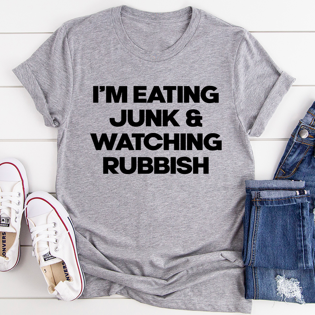 I'm Eating Junk & Watching Rubbish T-Shirt displayed on a mannequin, showcasing its soft cotton fabric and double-stitched neckline.