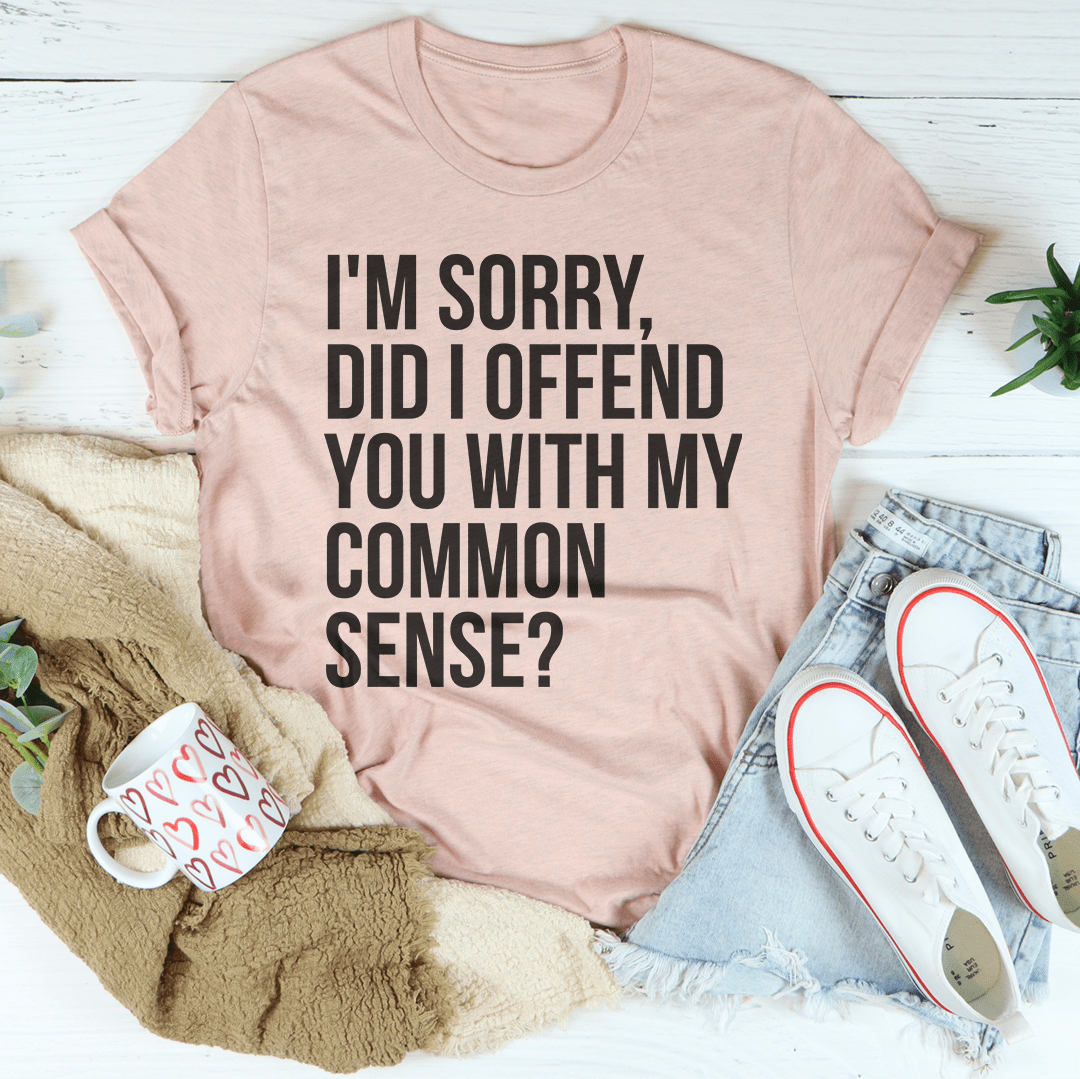 A stylish black t-shirt featuring the phrase 'I'm Sorry Did I Offend You With My Common Sense' printed in bold letters, showcasing its soft fabric and durable stitching.