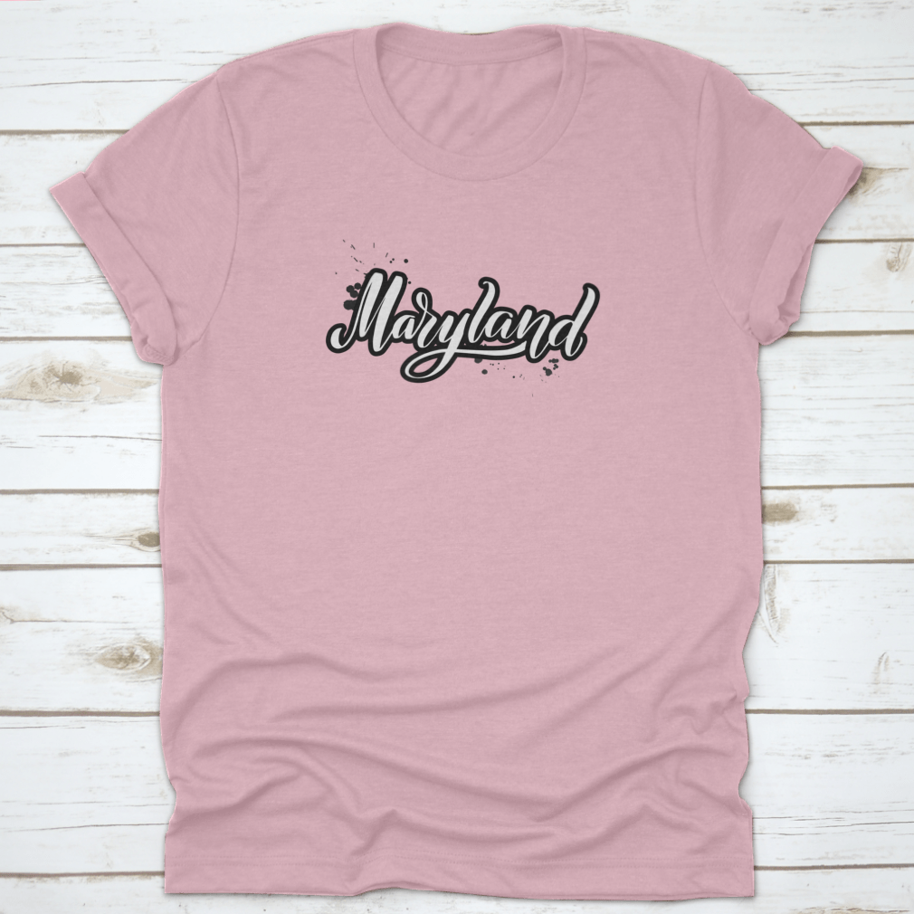 Inspirational handwritten brush lettering design featuring the word 'Maryland' in elegant vector calligraphy on a stylish apparel piece.