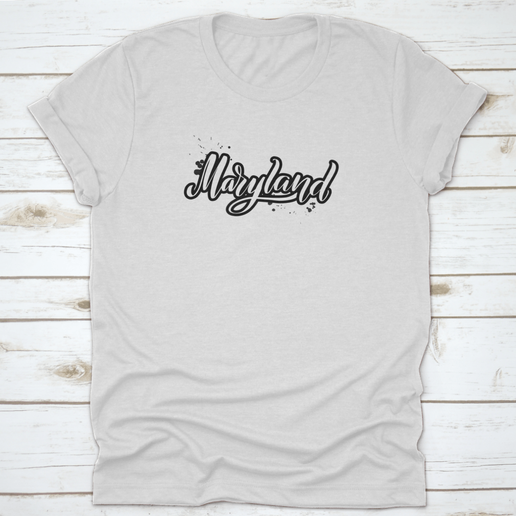 Inspirational handwritten brush lettering design featuring the word 'Maryland' in elegant vector calligraphy on a stylish apparel piece.