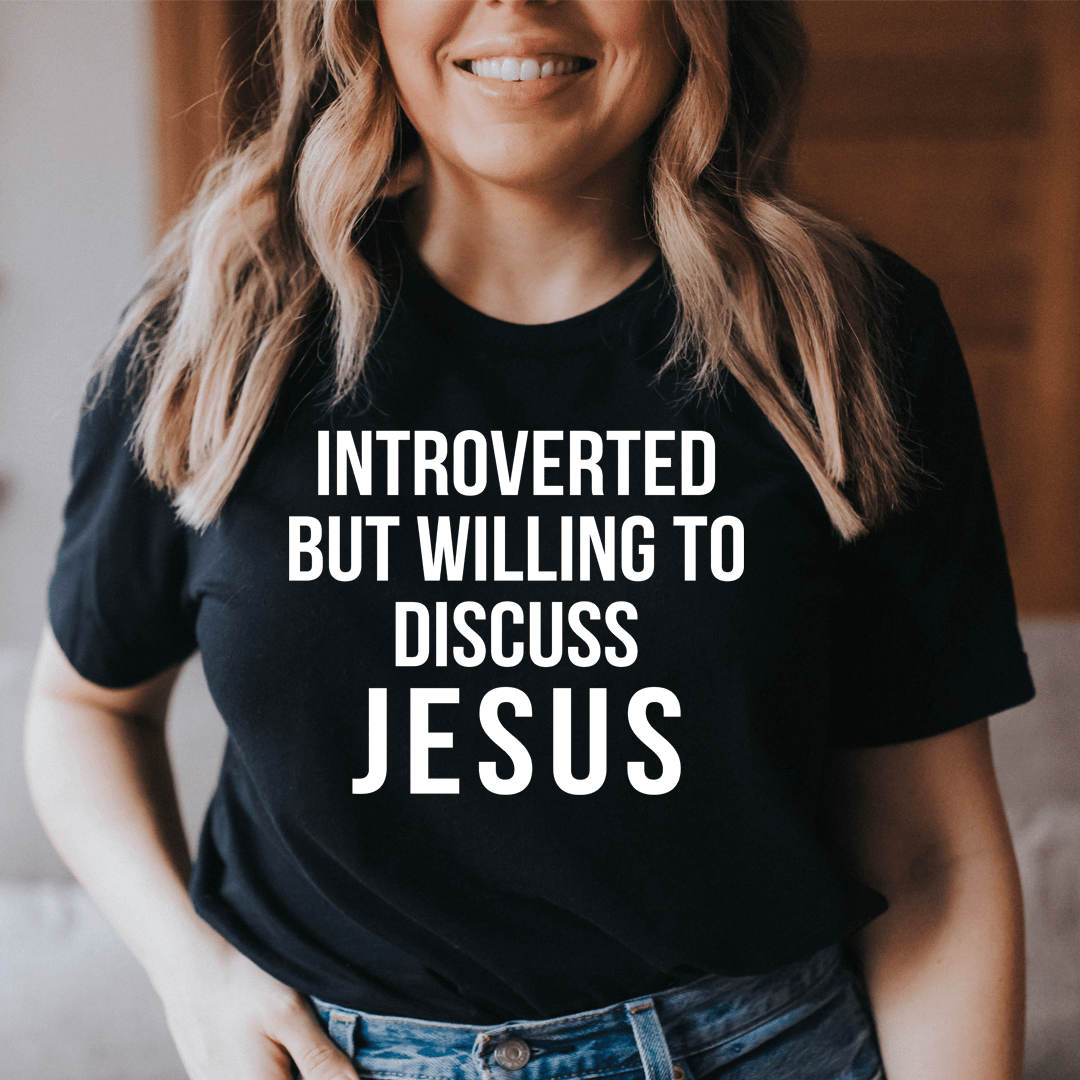 A comfortable and stylish t-shirt featuring the phrase 'Introverted But Willing To Discuss Jesus', made from soft ring-spun cotton.