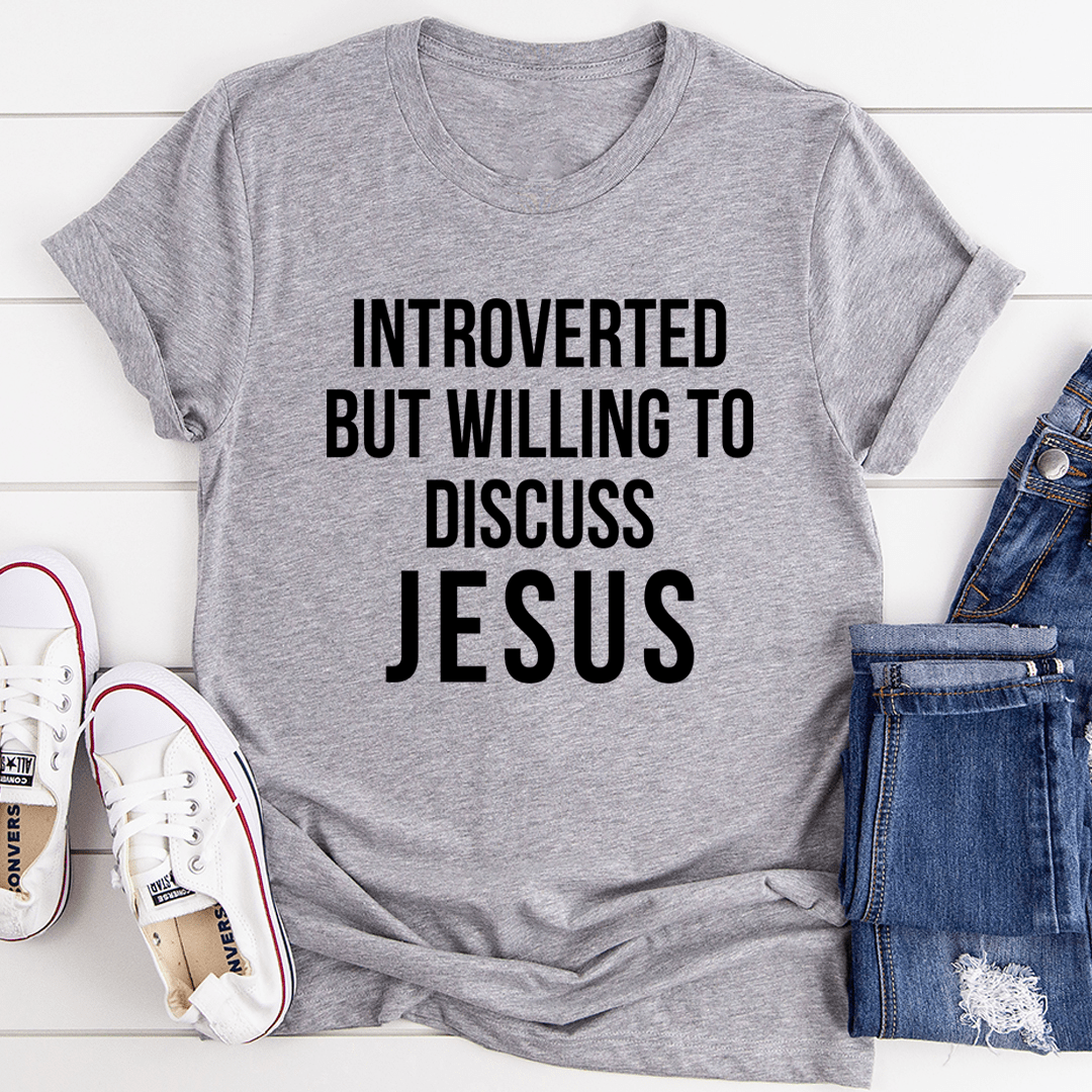 A comfortable and stylish t-shirt featuring the phrase 'Introverted But Willing To Discuss Jesus', made from soft ring-spun cotton.