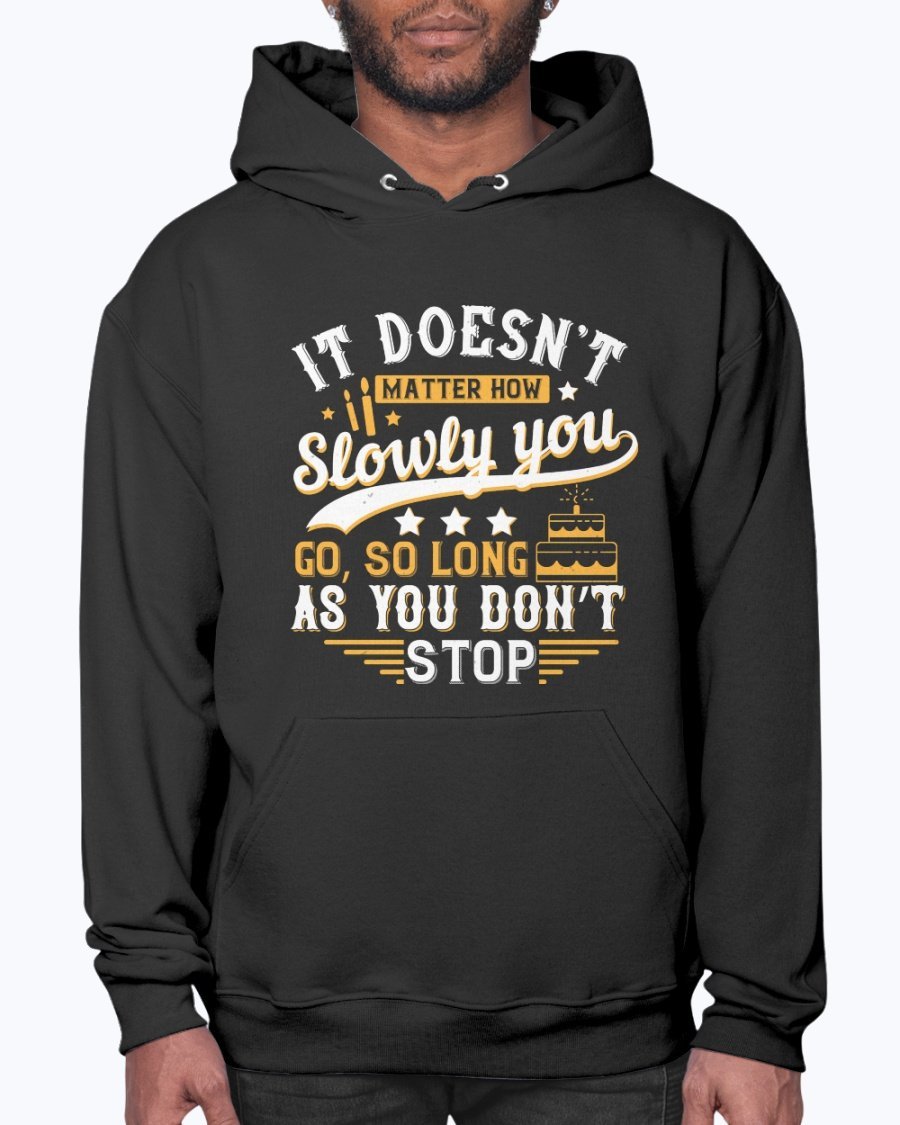 A cozy unisex hoodie featuring the motivational quote 'It doesn’t matter how slowly you go, so long as you don’t stop' in stylish font.