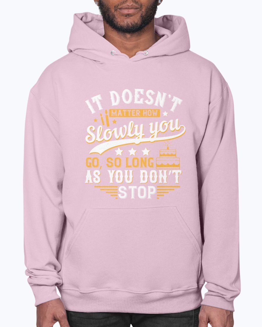 A cozy unisex hoodie featuring the motivational quote 'It doesn’t matter how slowly you go, so long as you don’t stop' in stylish font.