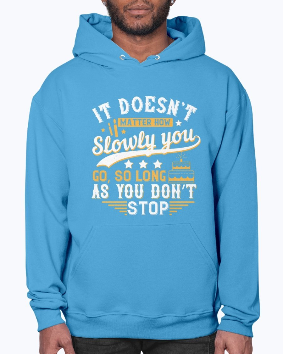 A cozy unisex hoodie featuring the motivational quote 'It doesn’t matter how slowly you go, so long as you don’t stop' in stylish font.