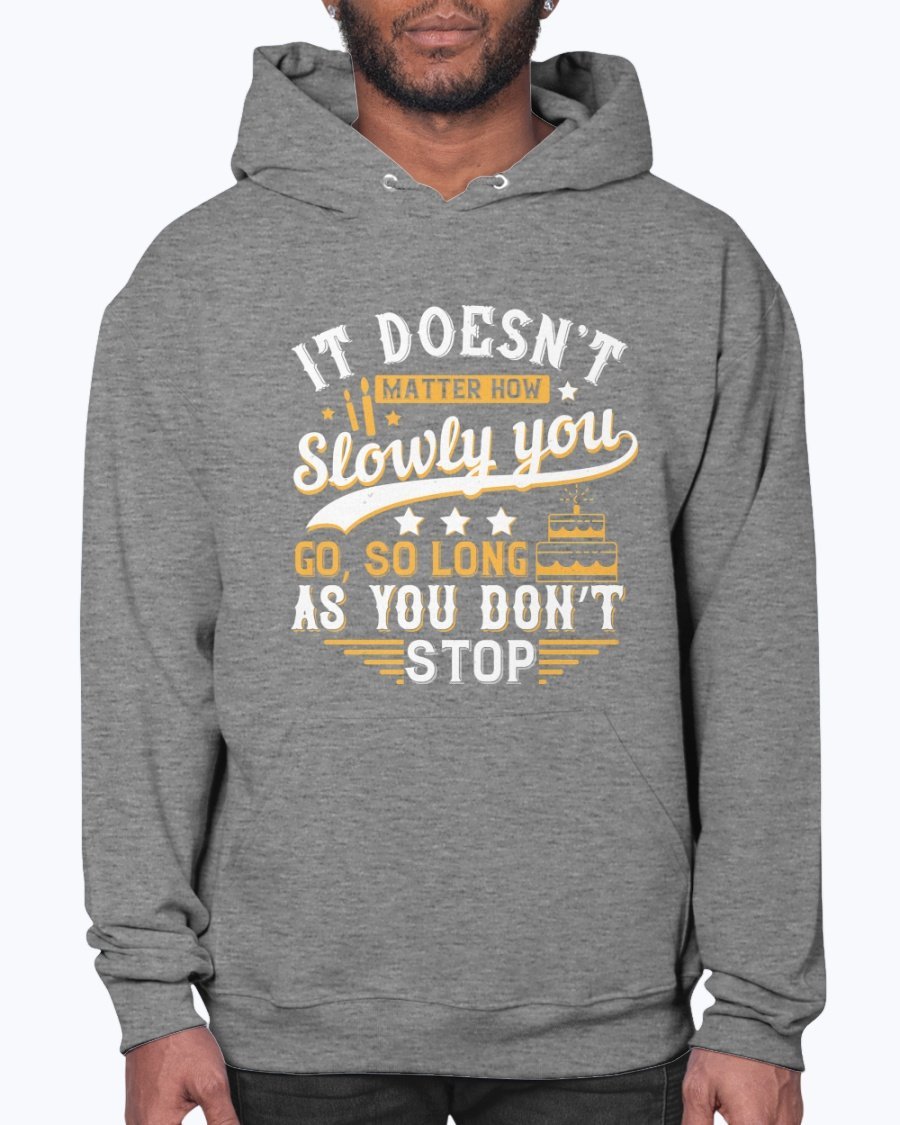 A cozy unisex hoodie featuring the motivational quote 'It doesn’t matter how slowly you go, so long as you don’t stop' in stylish font.