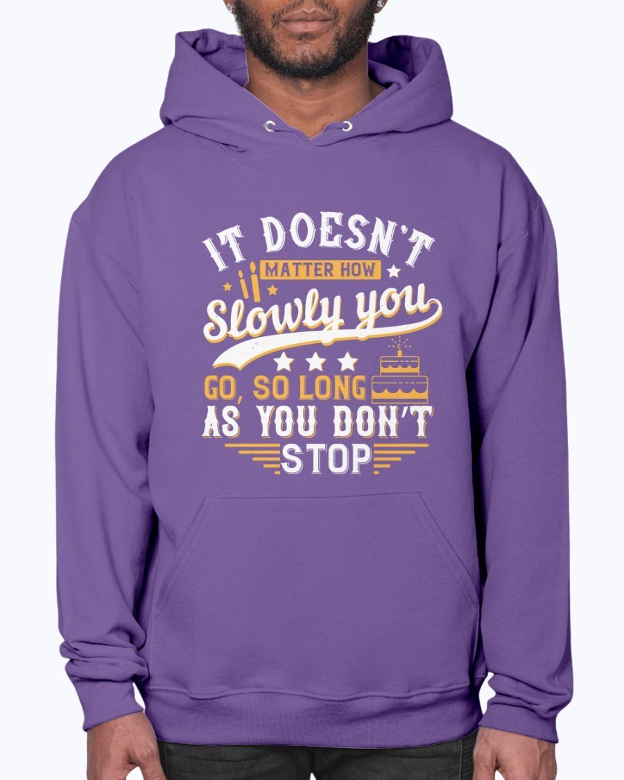 A cozy unisex hoodie featuring the motivational quote 'It doesn’t matter how slowly you go, so long as you don’t stop' in stylish font.