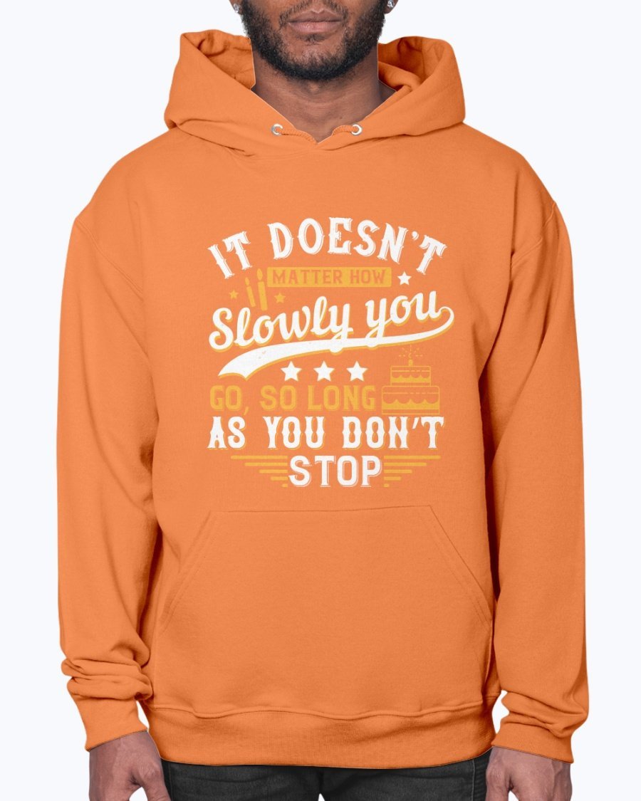 A cozy unisex hoodie featuring the motivational quote 'It doesn’t matter how slowly you go, so long as you don’t stop' in stylish font.