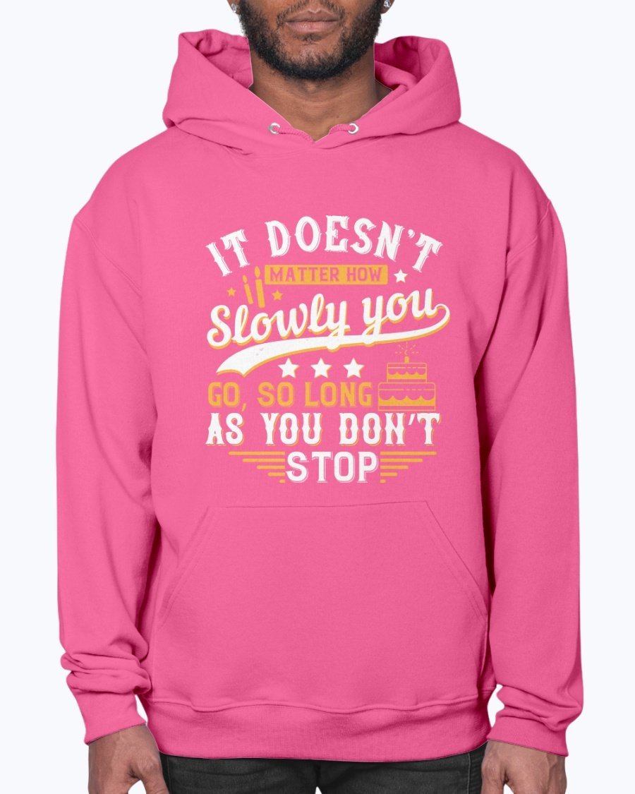 A cozy unisex hoodie featuring the motivational quote 'It doesn’t matter how slowly you go, so long as you don’t stop' in stylish font.