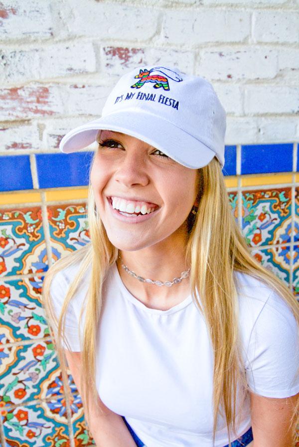 Embroidered bachelorette hats in white and soft pink with fun phrases for a fiesta theme.