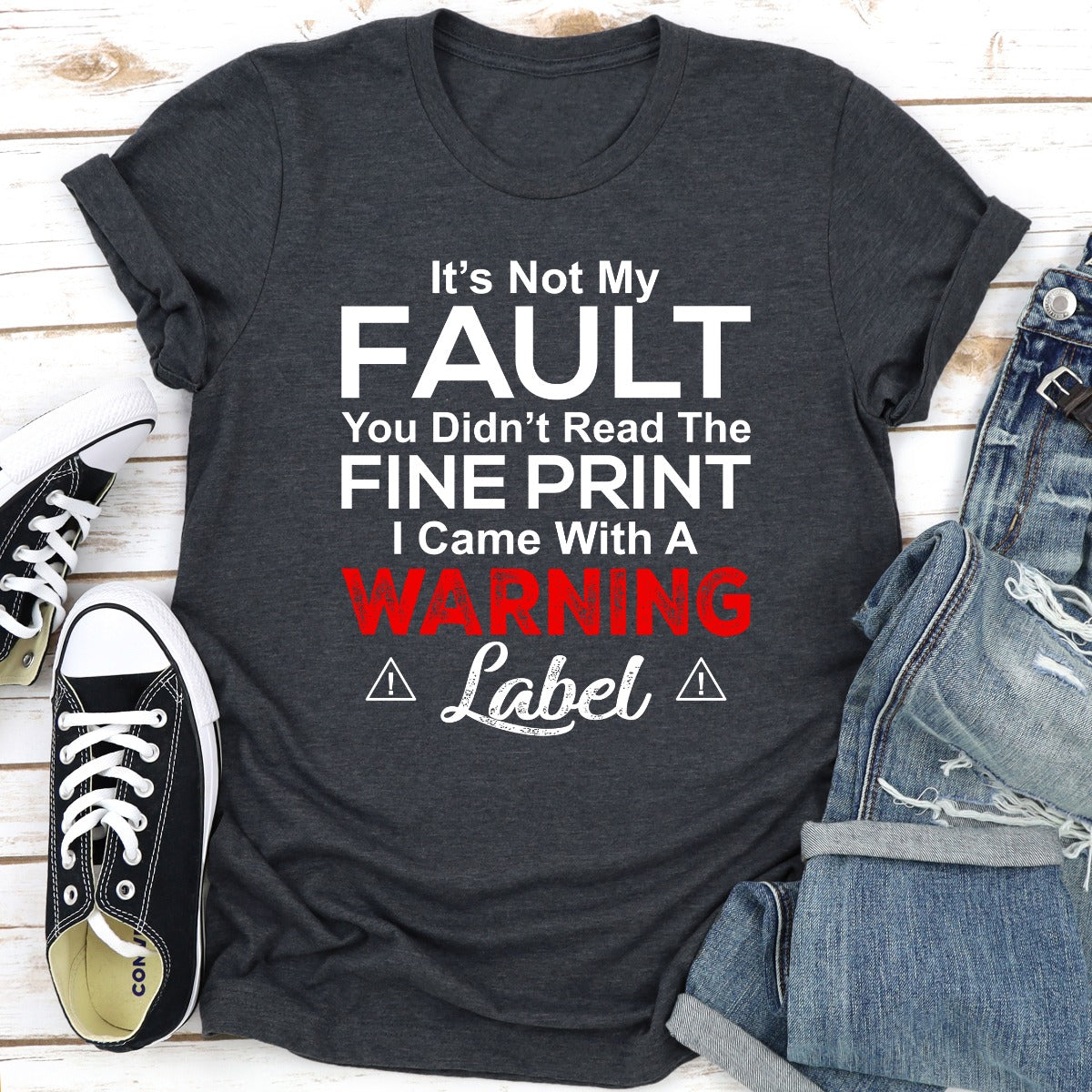 A stylish black t-shirt featuring the phrase 'It's Not My Fault You Didn't Read The Fine Print' printed in bold letters, showcasing its comfortable fit and quality fabric.