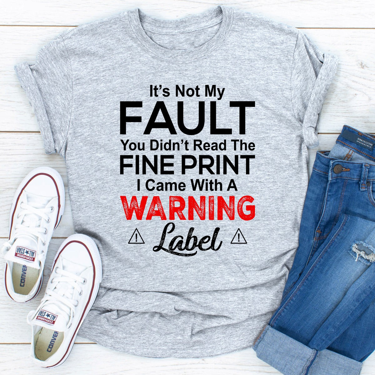 A stylish black t-shirt featuring the phrase 'It's Not My Fault You Didn't Read The Fine Print' printed in bold letters, showcasing its comfortable fit and quality fabric.