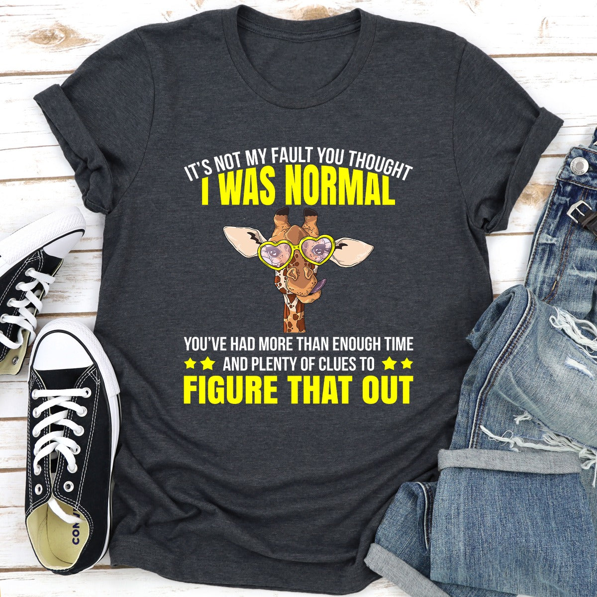 A stylish black t-shirt featuring the phrase 'It's Not My Fault You Thought I Was Normal' in bold white lettering, showcasing its comfortable fit and quality fabric.