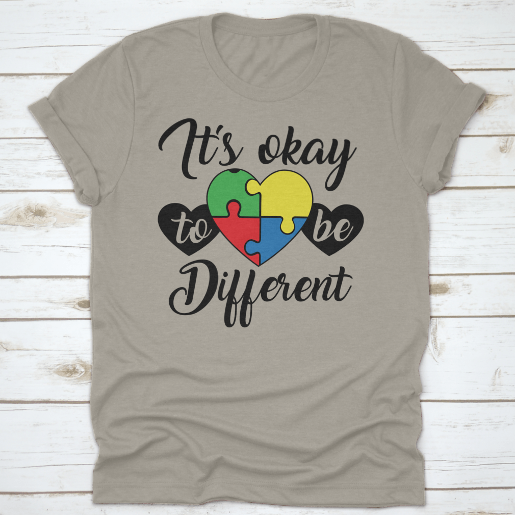 A soft, comfortable T-shirt featuring the phrase 'It's Okay To Be Different' in a stylish design, perfect for casual wear.