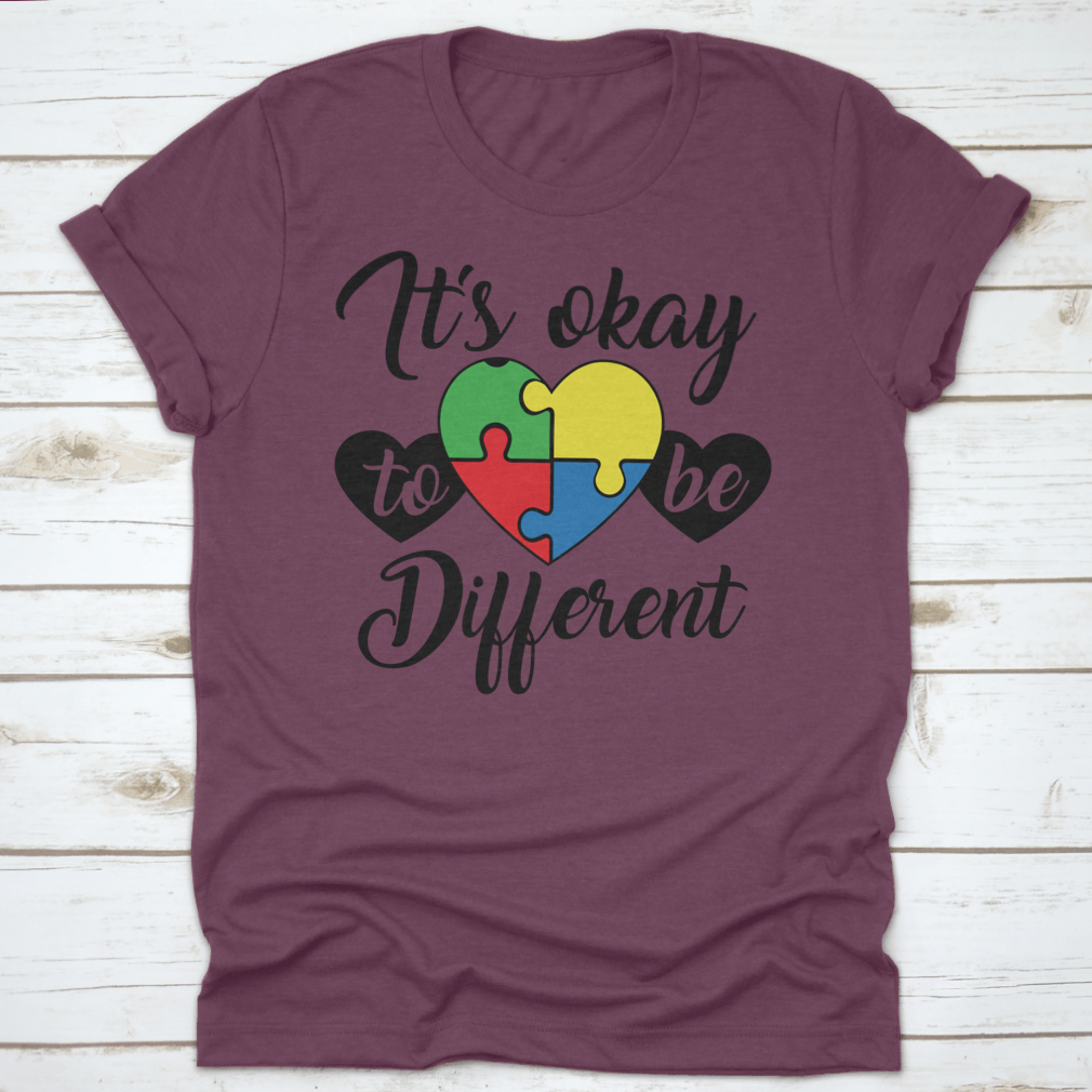 A soft, comfortable T-shirt featuring the phrase 'It's Okay To Be Different' in a stylish design, perfect for casual wear.