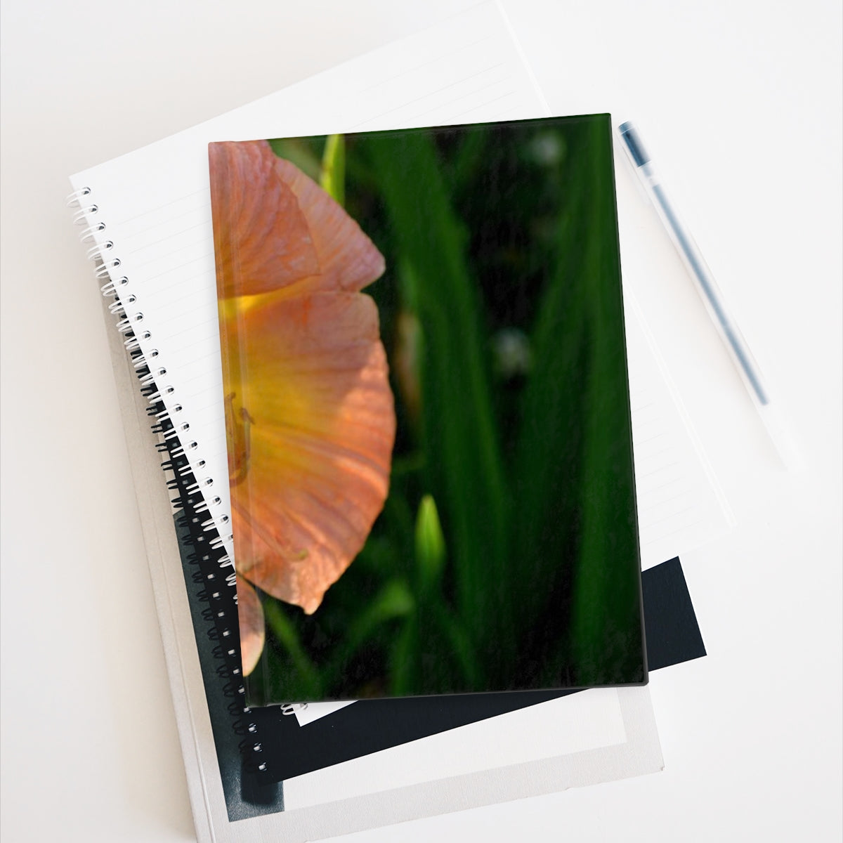 A hardcover blank journal with a vibrant wraparound print, showcasing its 128 blank pages for creativity.