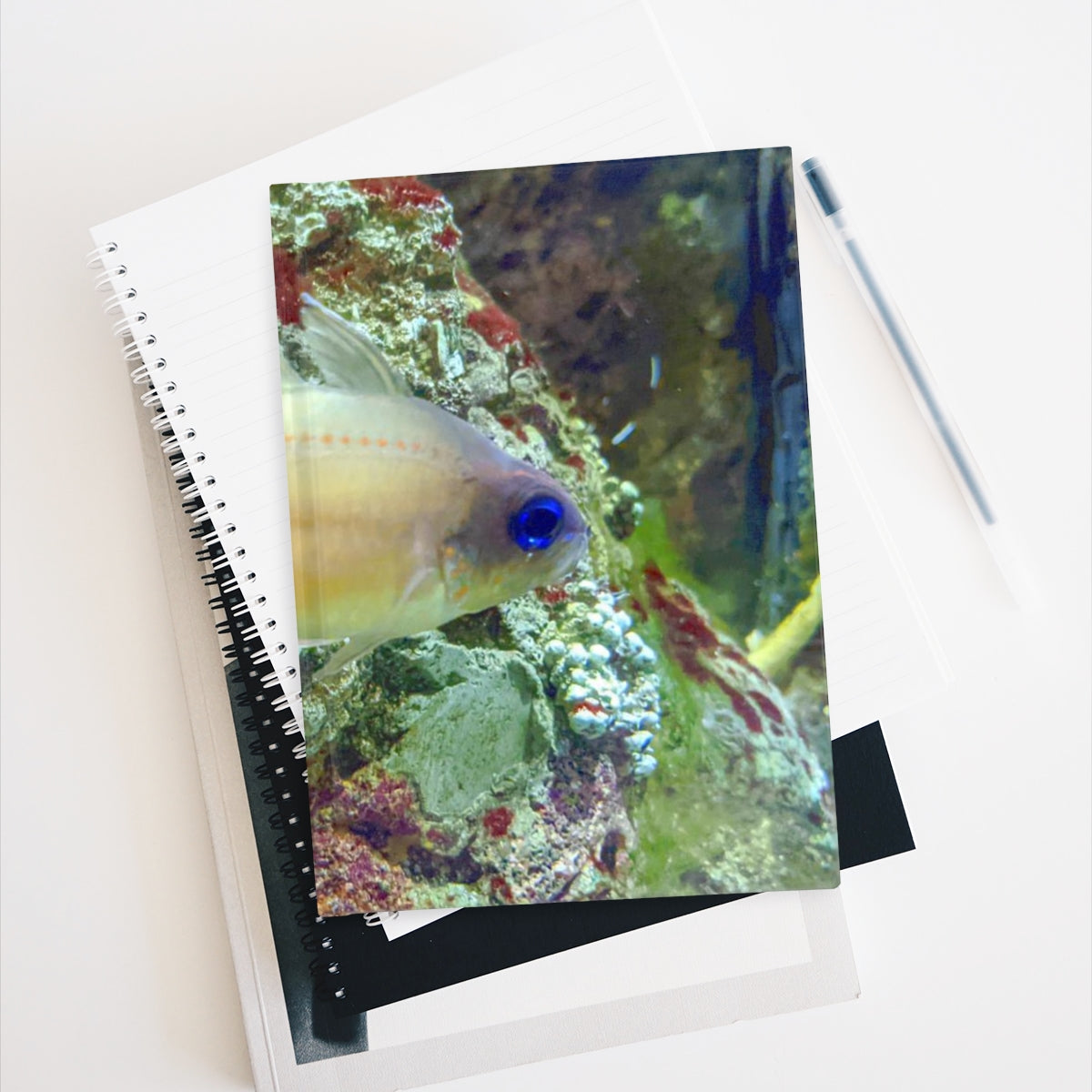 A hardcover blank journal with a colorful wraparound print, showcasing its 128 blank pages for creativity.