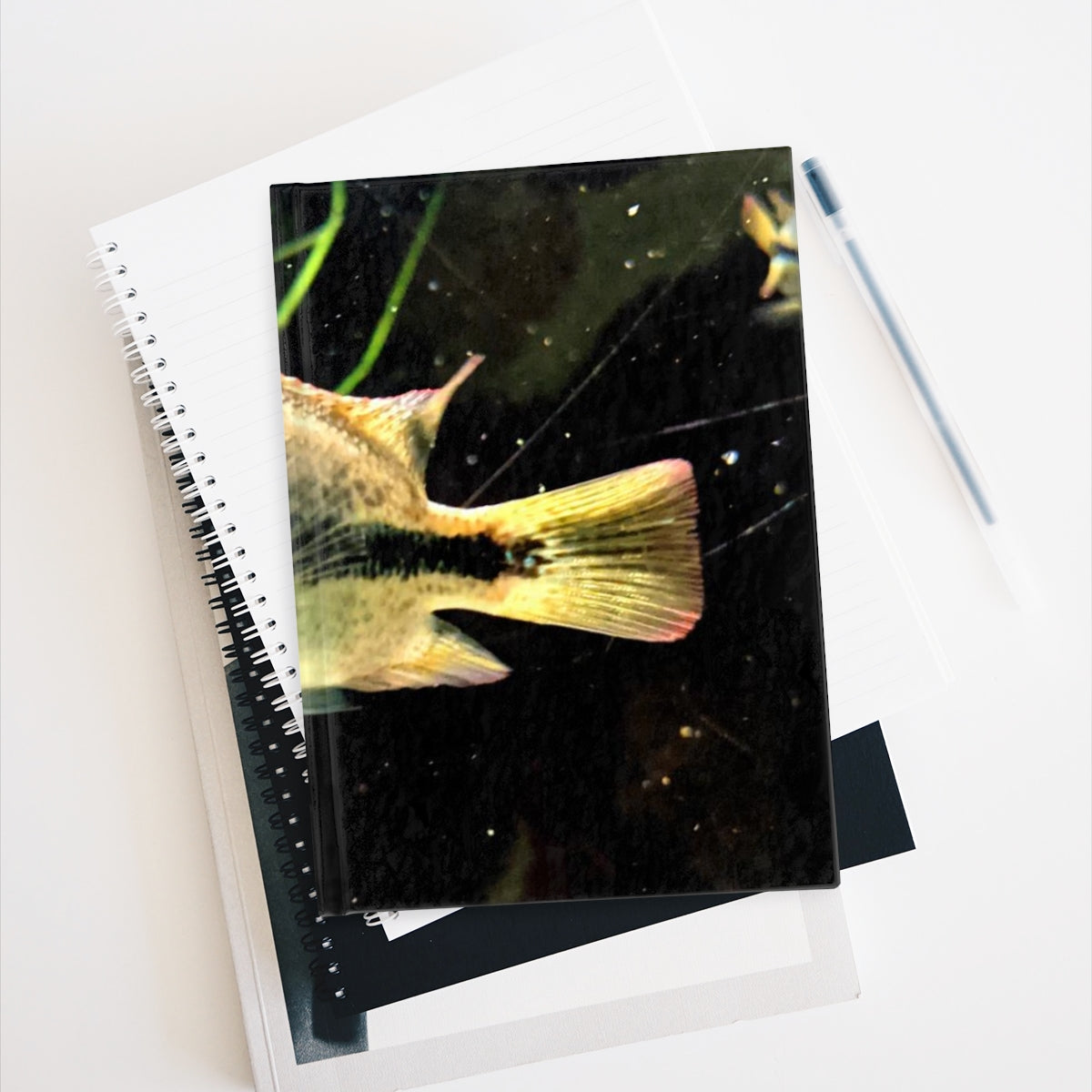 A hardcover journal with ruled lines, featuring a full wraparound print design, ideal for writers and note-takers.