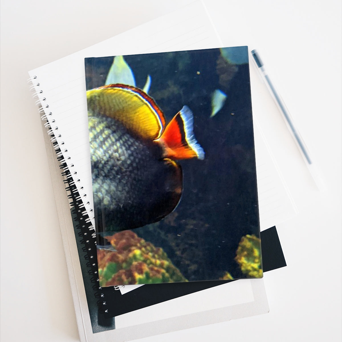 Hardcover journal with ruled lines and vibrant wraparound print, perfect for writers.