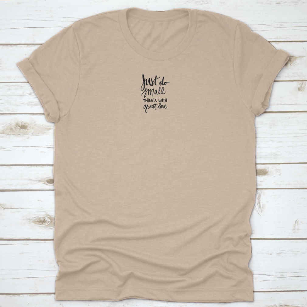 A soft cotton t-shirt featuring the inspiring phrase 'Just Do Small Things With Great Love' in a stylish font, perfect for casual wear.