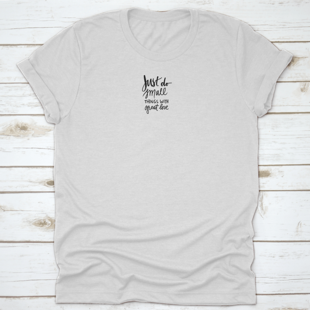 A soft cotton t-shirt featuring the inspiring phrase 'Just Do Small Things With Great Love' in a stylish font, perfect for casual wear.