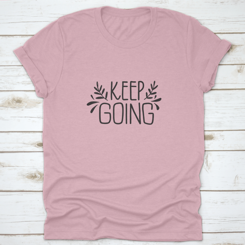 A stylish shirt featuring hand-drawn lettering that says 'Keep Going', showcasing modern brush calligraphy on a comfortable fabric.