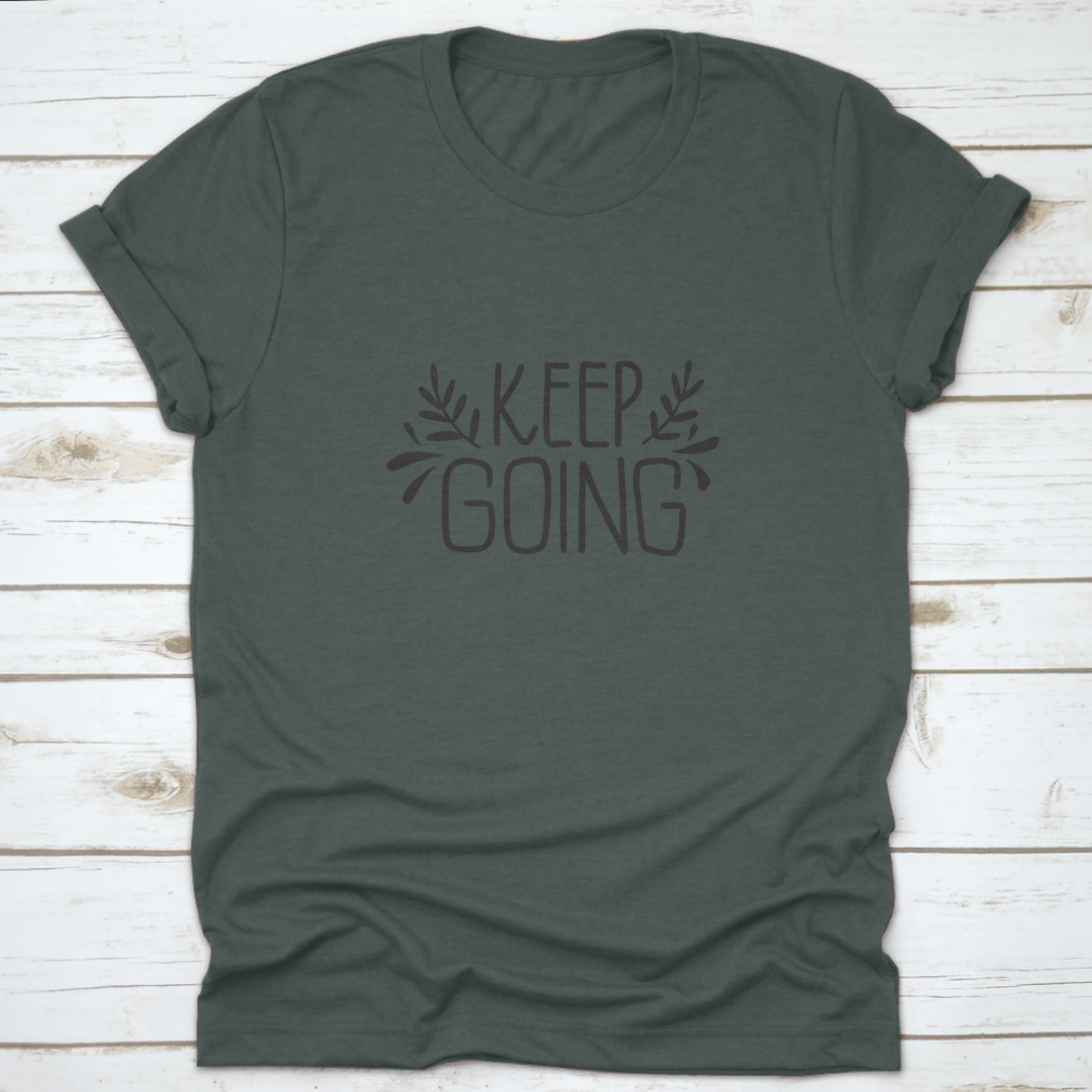 A stylish shirt featuring hand-drawn lettering that says 'Keep Going', showcasing modern brush calligraphy on a comfortable fabric.