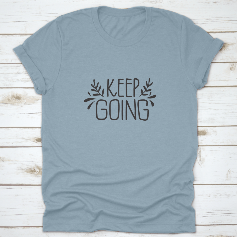 A stylish shirt featuring hand-drawn lettering that says 'Keep Going', showcasing modern brush calligraphy on a comfortable fabric.