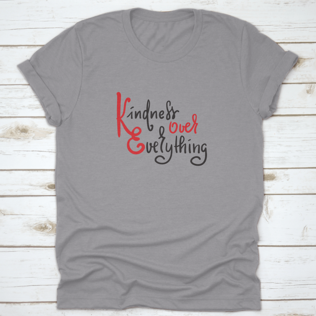 A hand-drawn motivational quote t-shirt featuring 'Kindness Over Everything' in stylish typography, made from soft cotton fabric.