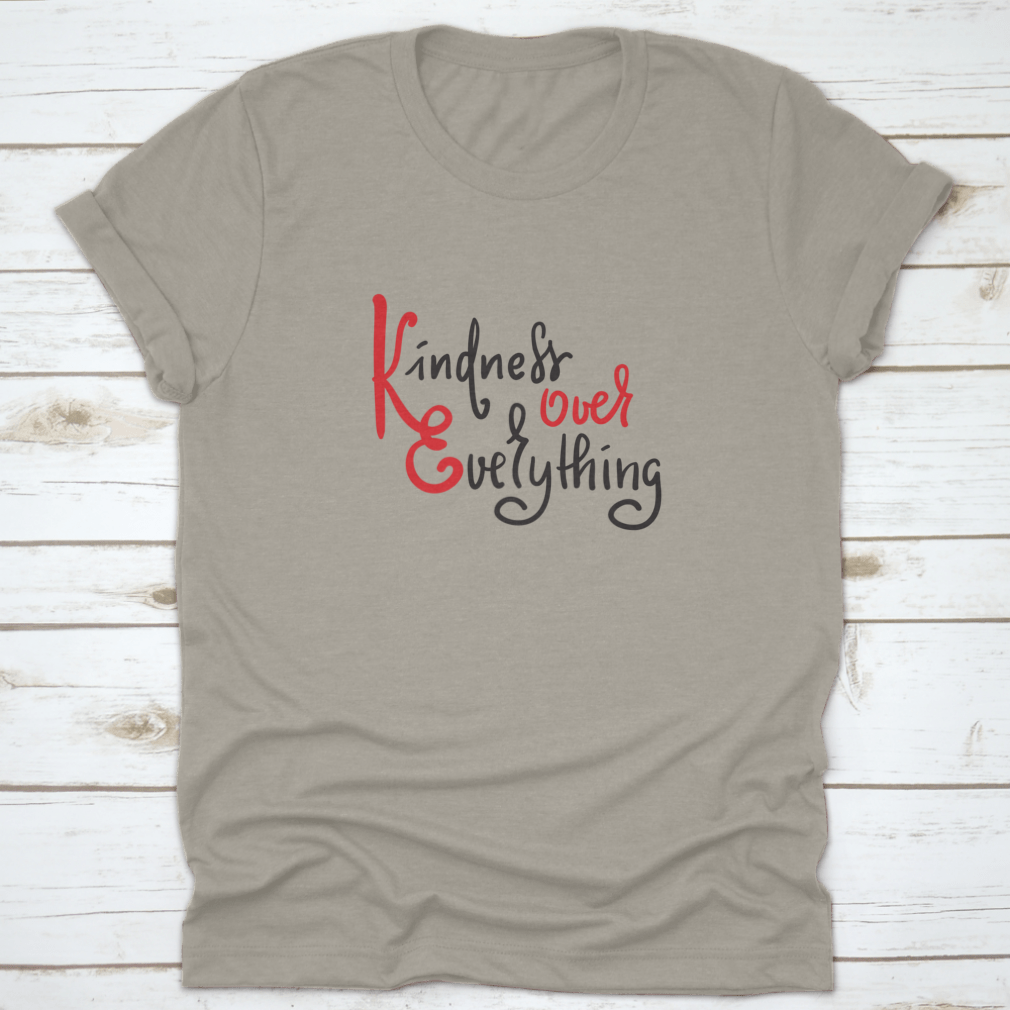 A hand-drawn motivational quote t-shirt featuring 'Kindness Over Everything' in stylish typography, made from soft cotton fabric.