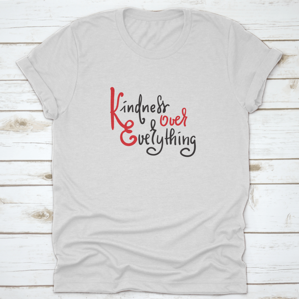 A hand-drawn motivational quote t-shirt featuring 'Kindness Over Everything' in stylish typography, made from soft cotton fabric.