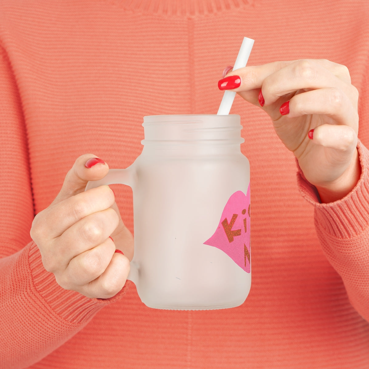 A personalized Kiss Me Mason Jar made of frosted glass, featuring a straw and lid, perfect for drinks.