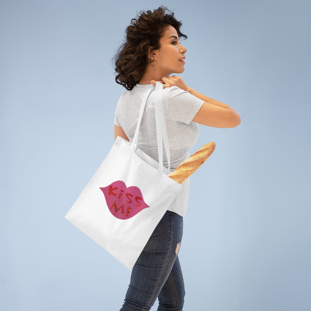 Kiss Me Tote Bag made of 100% cotton with long handles and cross stitching, available in multiple colors.