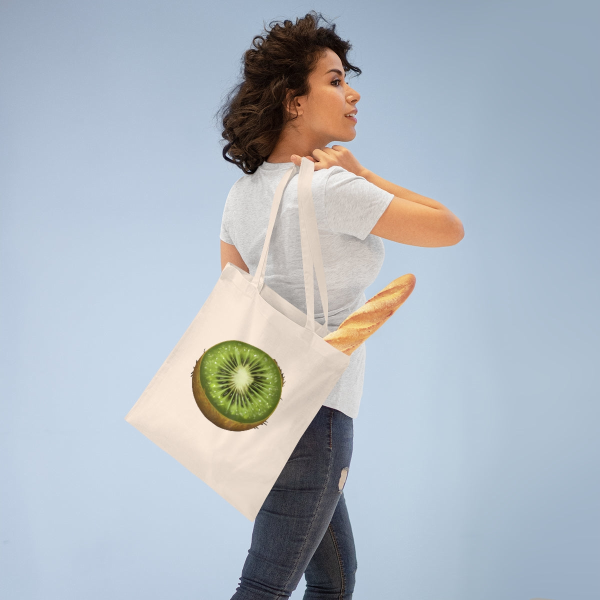 A vibrant Kiwi Tote Bag made of 100% cotton with long handles and cross-stitched detailing, showcasing multiple color options.