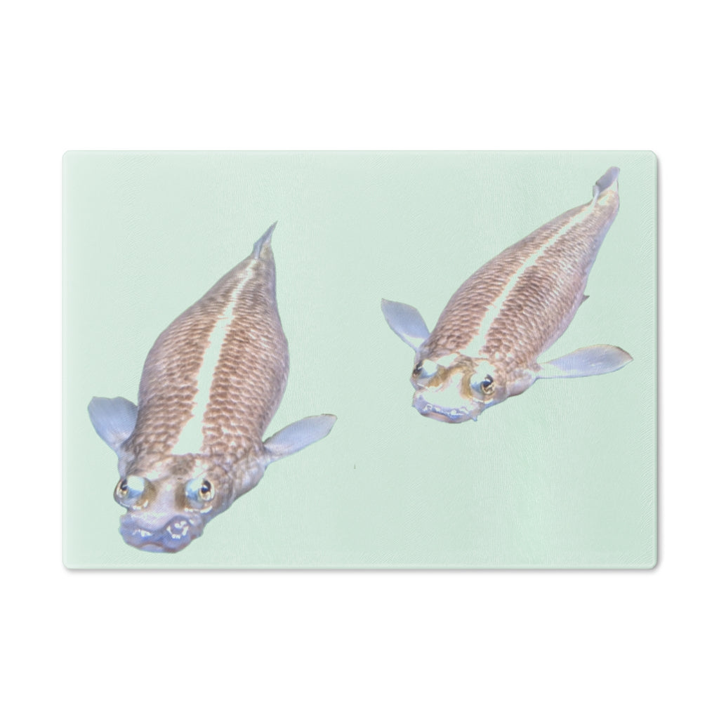 A beautifully designed Koi Fish Cutting Board made of tempered glass, featuring a unique Koi fish pattern and rubber dots for stability.