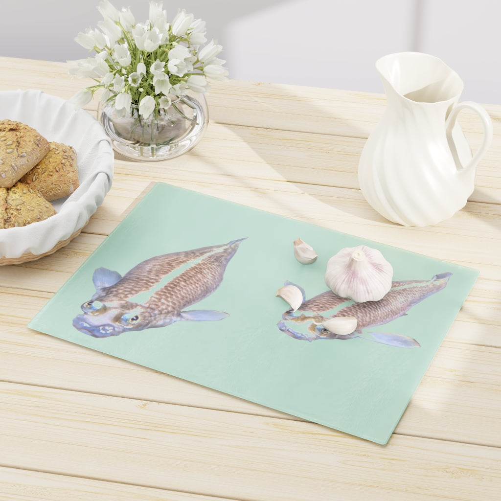 A beautifully designed Koi Fish Cutting Board made of tempered glass, featuring a unique Koi fish pattern and rubber dots for stability.