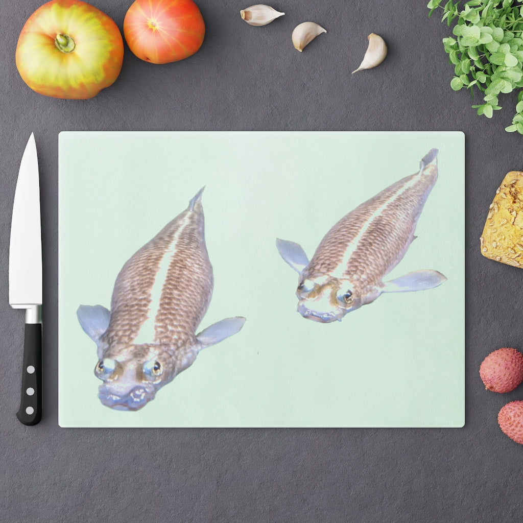 A beautifully designed Koi Fish Cutting Board made of tempered glass, featuring a unique Koi fish pattern and rubber dots for stability.